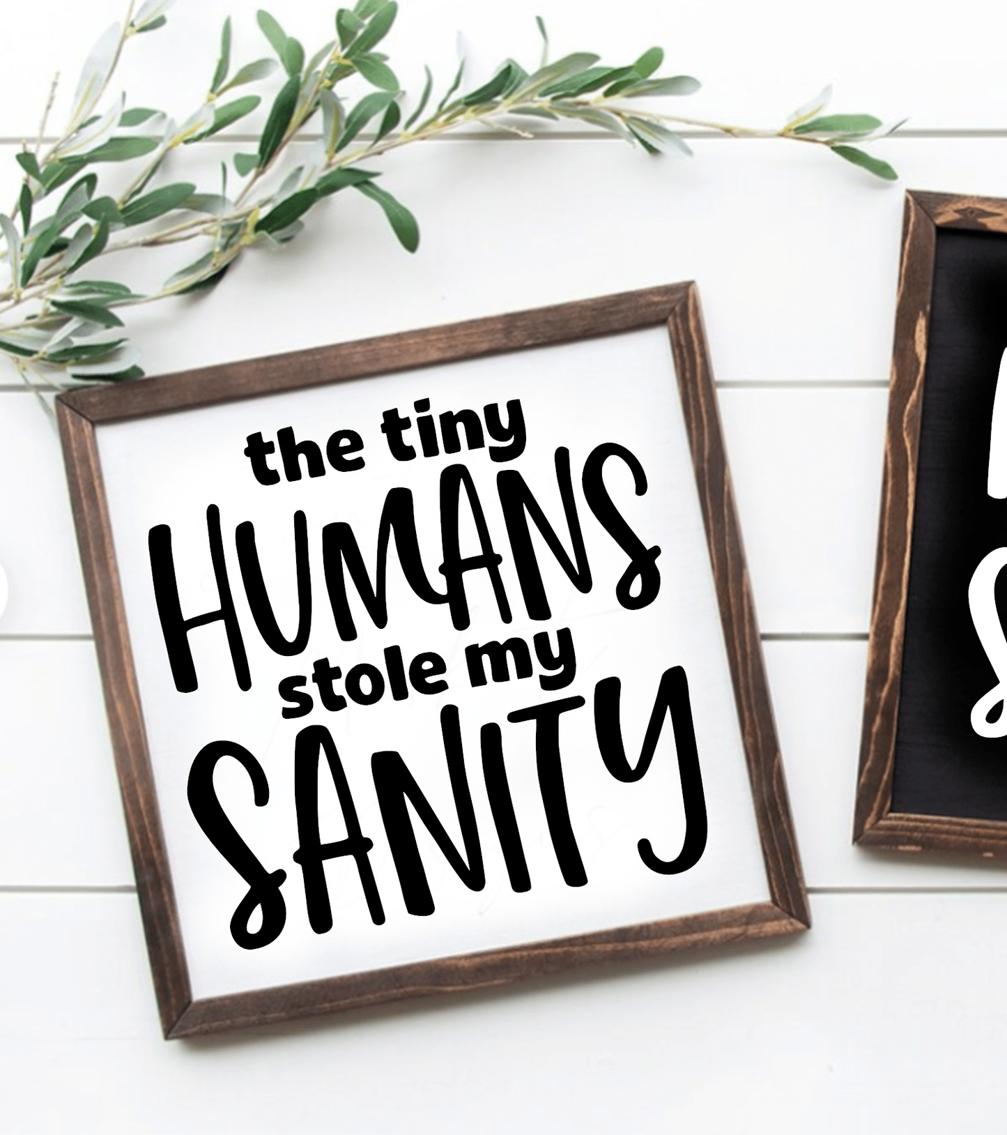 Wooden sign with "The Tiny Humans Stole my Sanity" message, black lettering on white background, framed.