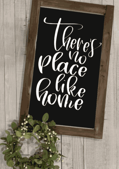 There is No Place like Home framed wood sign with black background and white lettering.