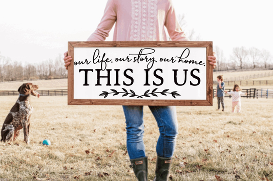 Framed farmhouse wood sign with "This is Us" text.