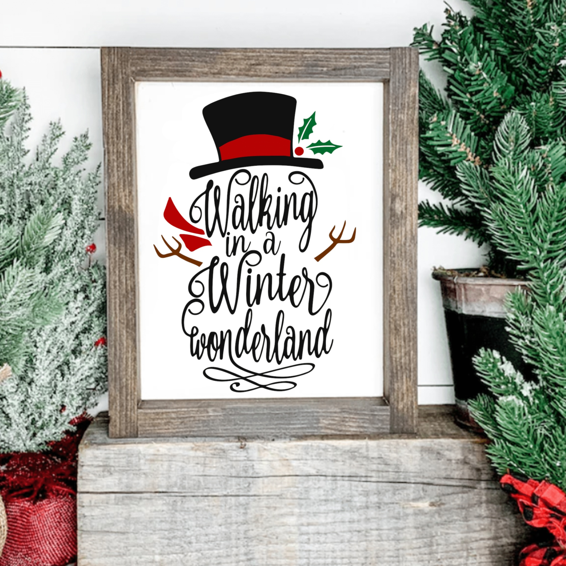Festive snowman sign with "Walking in a Winter Wonderland" text, top hat, and red scarf on a wood frame.