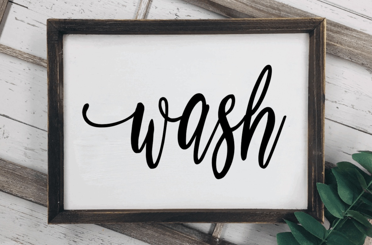 Rustic wood sign with the word "wash" in decorative script for laundry room decor.