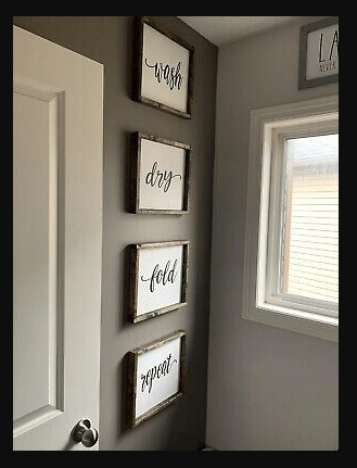 Wooden laundry room signs reading "Wash, Dry, Fold, Repeat," in rustic stained frames.
