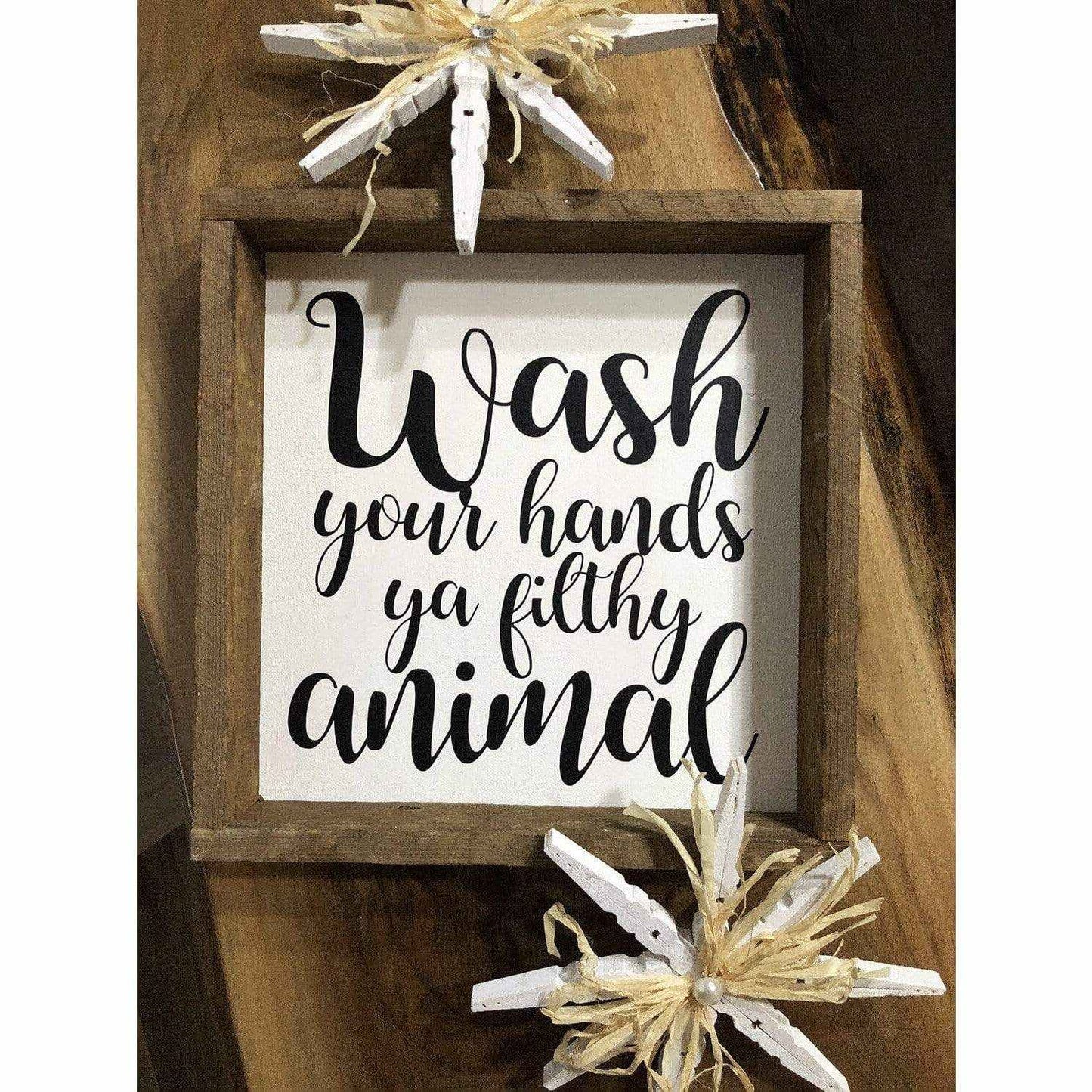 Framed wood sign with "Wash Your Hands Ya Filthy Animal" in black lettering on white background.