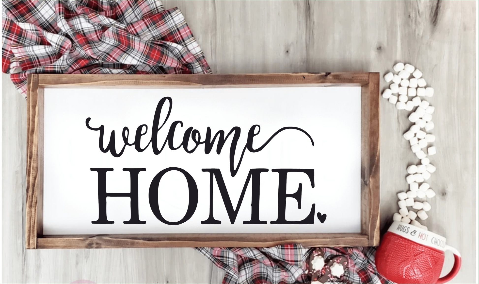 Welcome Home framed wood sign with white background and dark wooden frame.