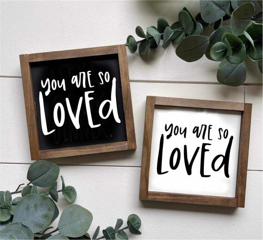 Hand-painted "You Are Loved" sign with wood frame, available in white or black background.