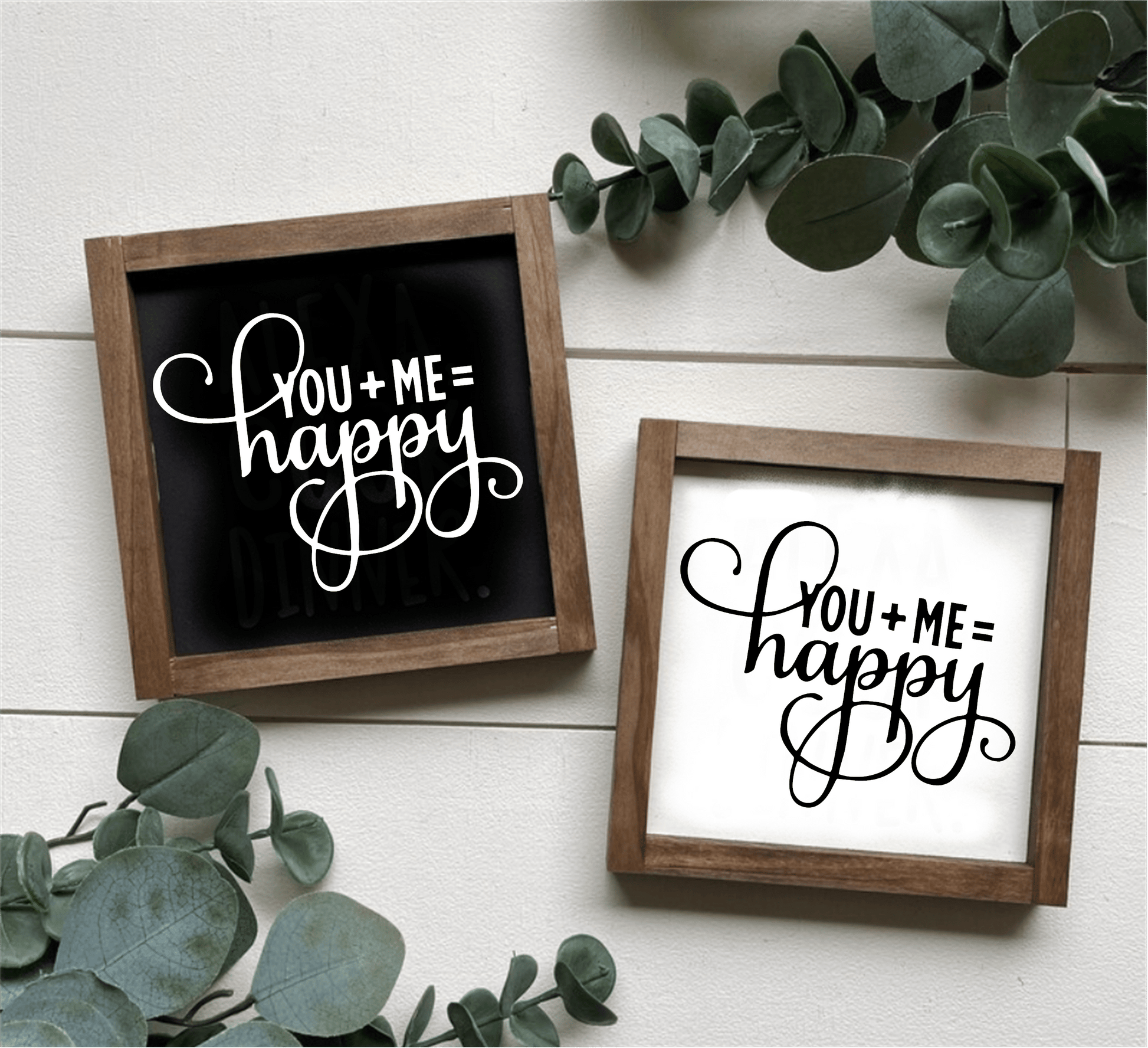 Handcrafted "You Plus Me Equals Happy" wood sign with black and white options, framed and decorated with greenery.