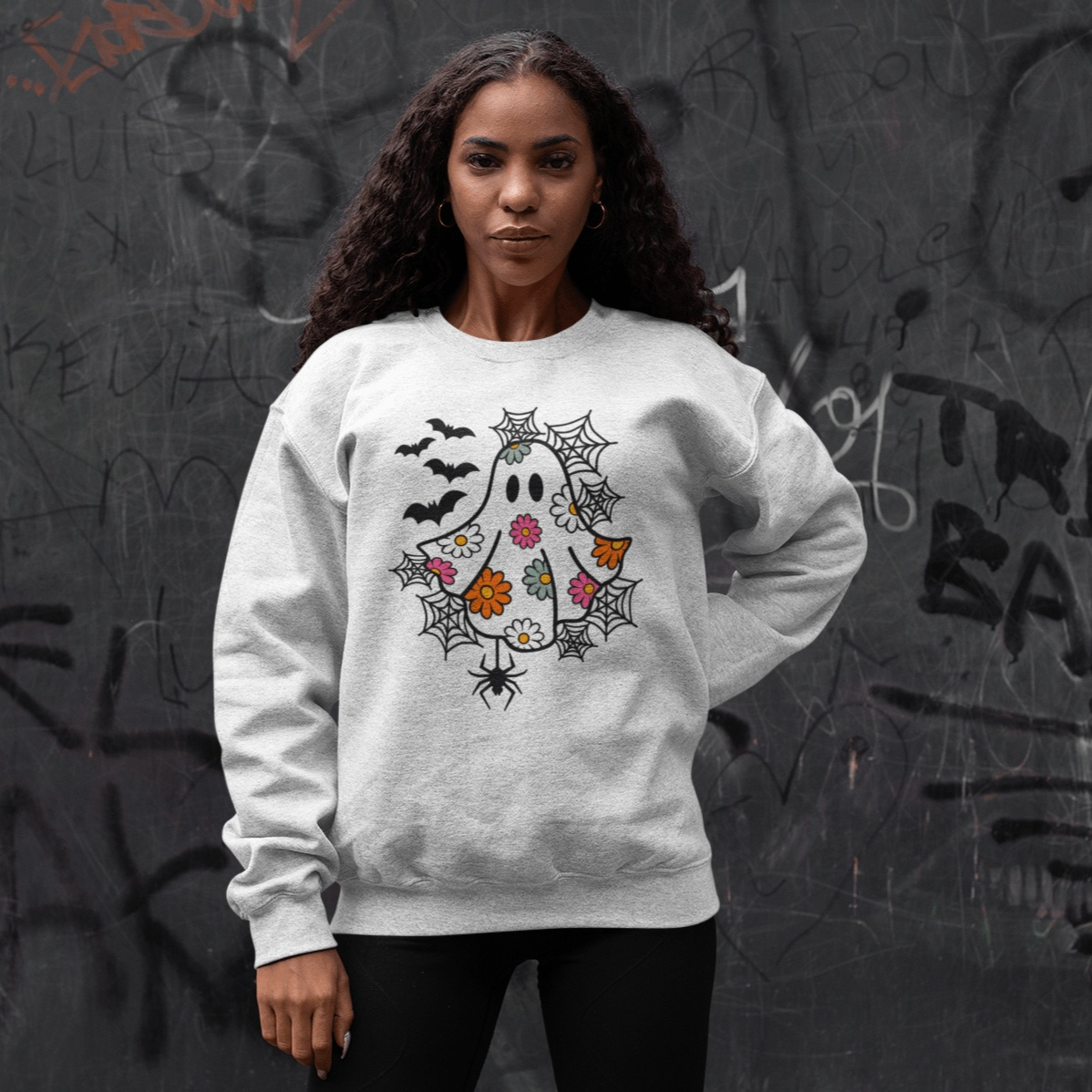 Women's Halloween ghost sweatshirt with floral and bat design.