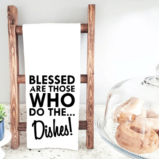 Tea towel with "Blessed are Those Who Do The Dishes" message on wooden ladder, kitchen decor.