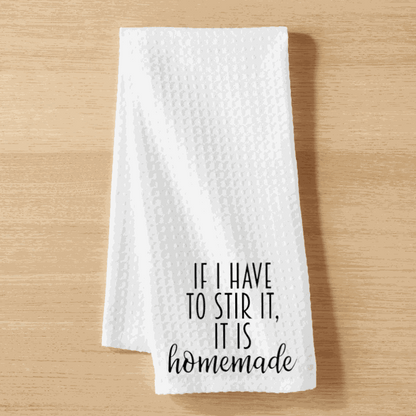 White microfiber tea towel with "If I have to Stir it, it is Homemade" text, waffle weave design, 16x24 inches.