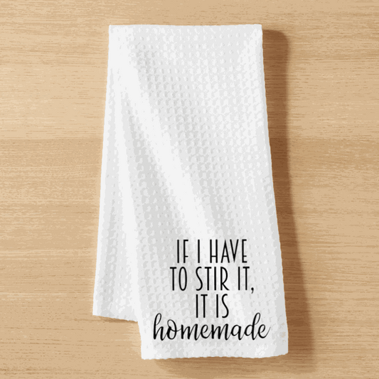 White microfiber tea towel with "If I have to Stir it, it is Homemade" text, waffle weave design, 16x24 inches.