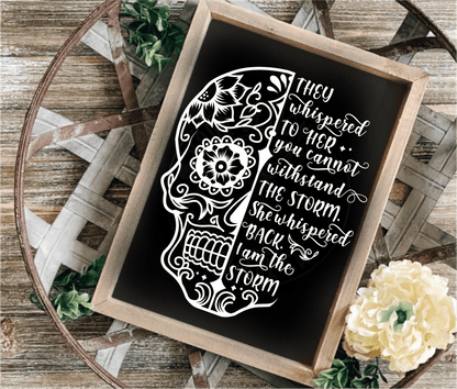 Inspirational wood frame sign with floral skull design and motivational quote on black background.