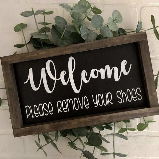 Handmade wood sign with "Welcome Please Remove Your Shoes" text in black and white, featuring a stained frame, perfect for entryway decor.