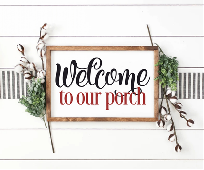 Welcome To Our Porch wood sign with stained frame and decorative greenery.