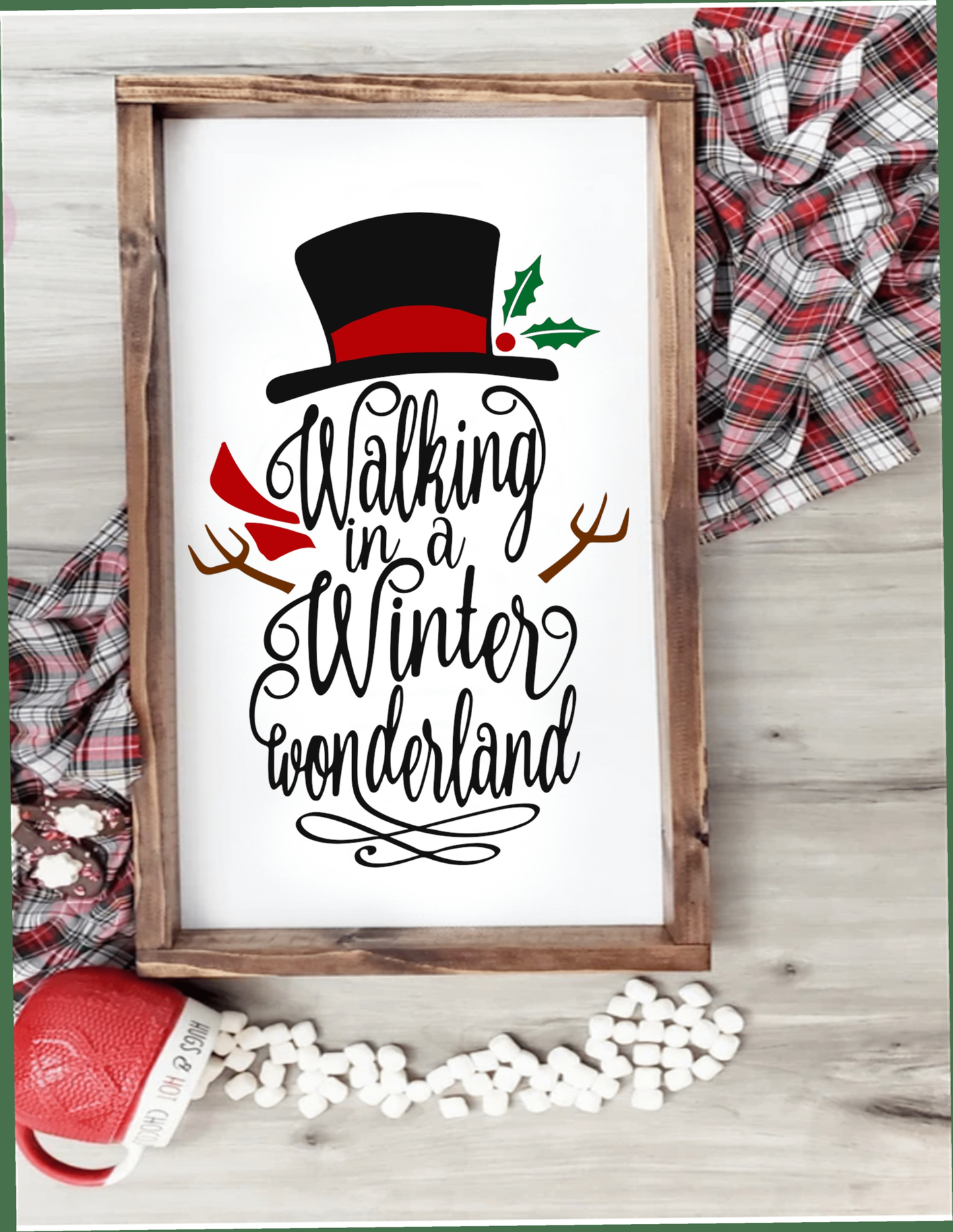 Walking in a Winter Wonderland framed snowman sign with festive decor elements.