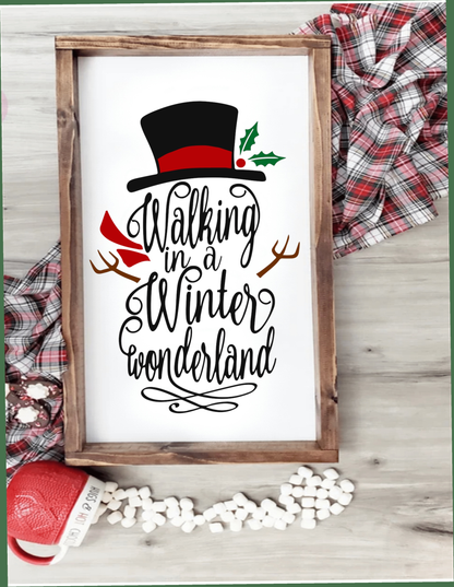Walking in a Winter Wonderland framed snowman sign with festive decor elements.