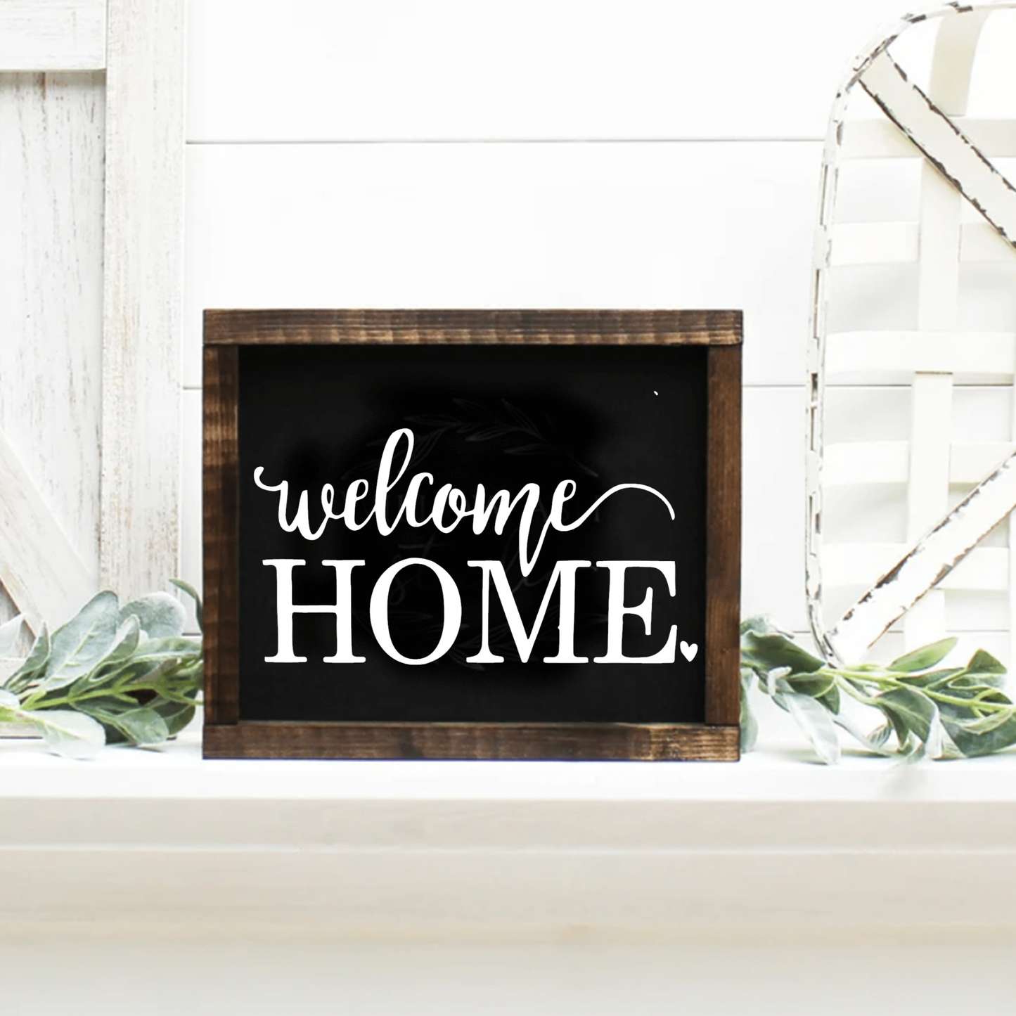 Handmade "Welcome Home" framed wood sign with dark wooden frame and customizable rustic finish.